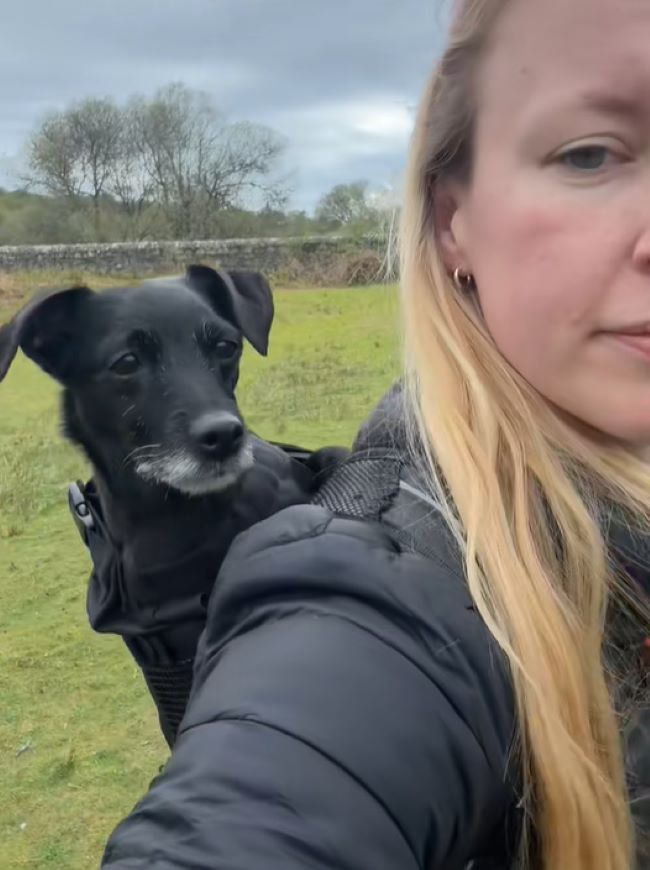 blonde woman and black dog