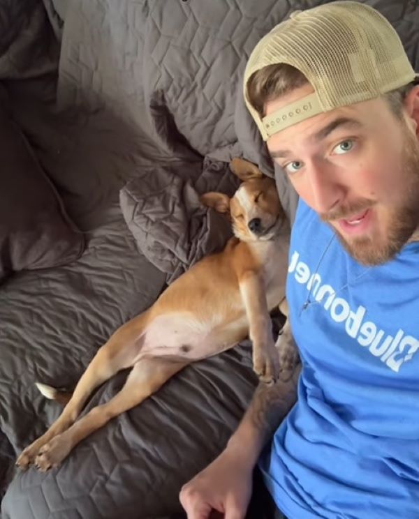 man and puppy sitting on couch