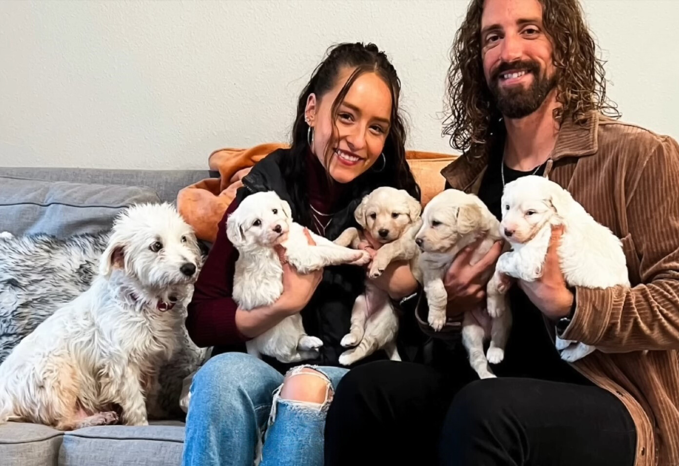 man, woman and puppies