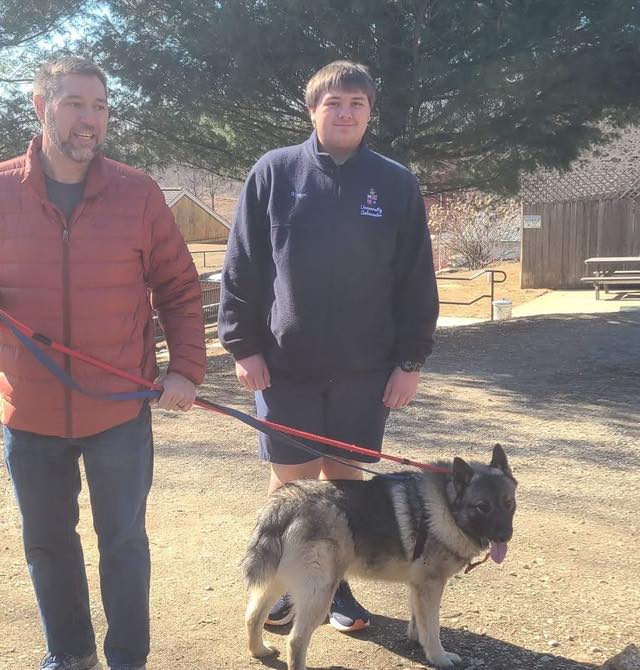 men and dog