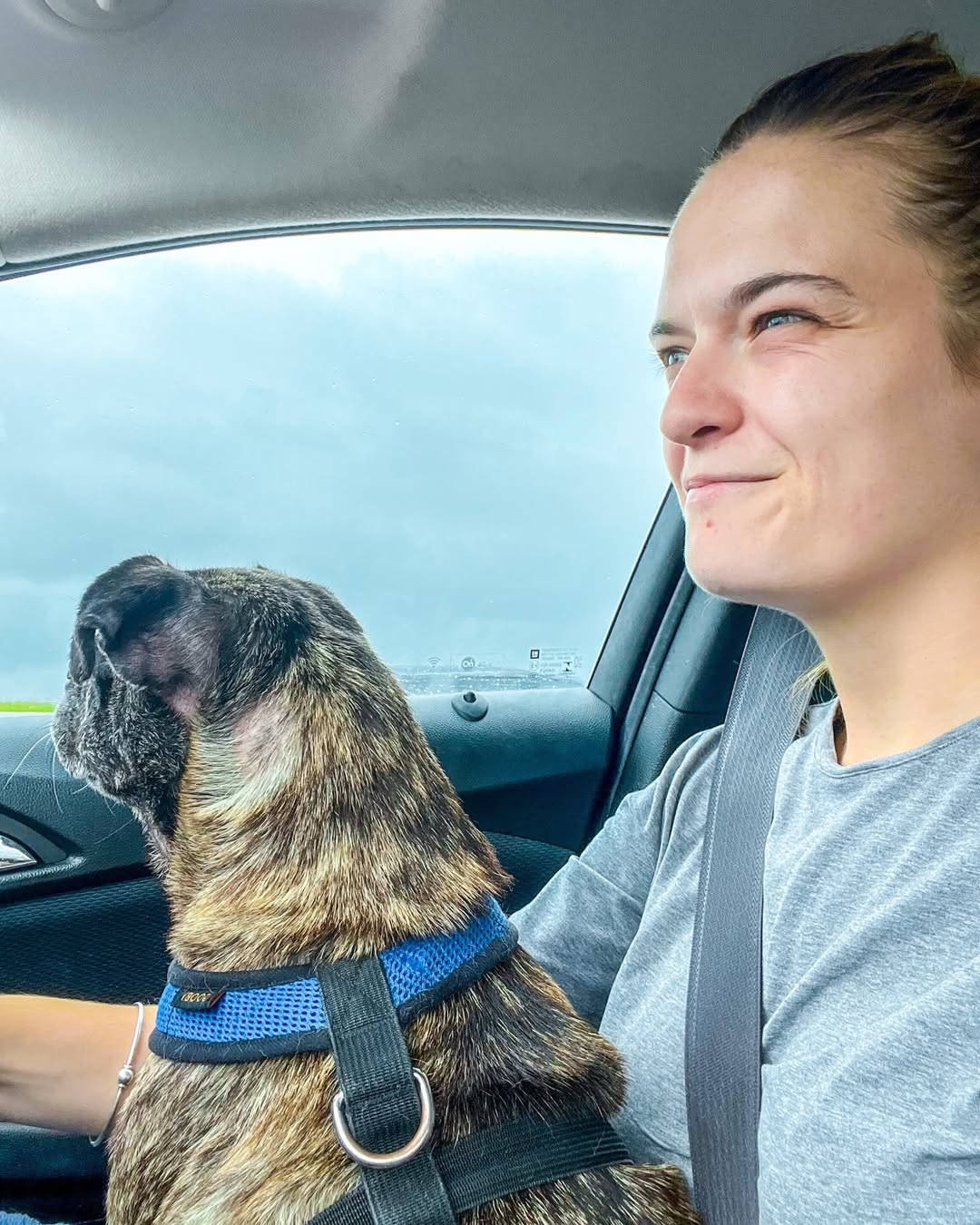 woman and dog in car