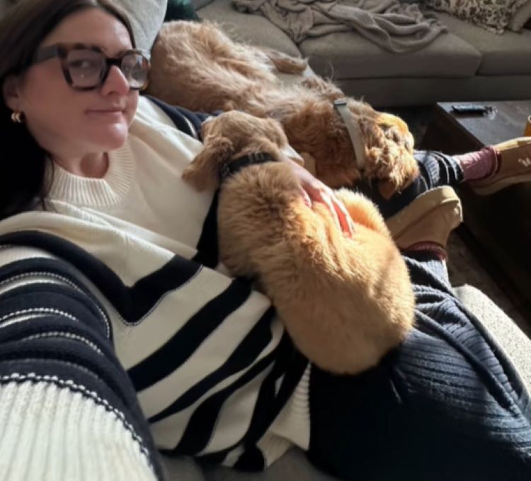 woman cuddling with dogs