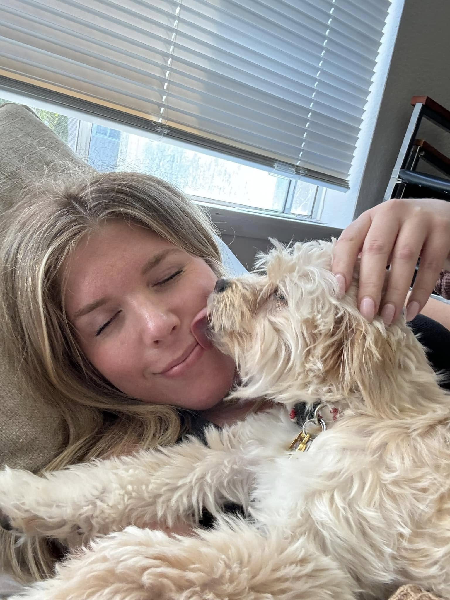 blonde woman and white puppy