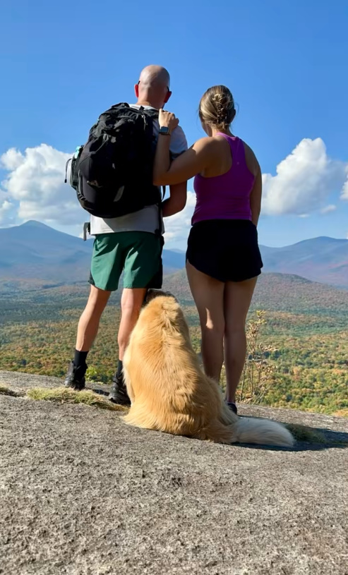 couple and Golden Retriever