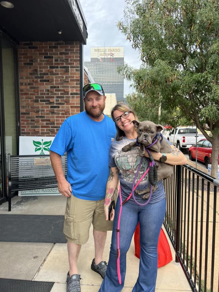 couple and gray dog