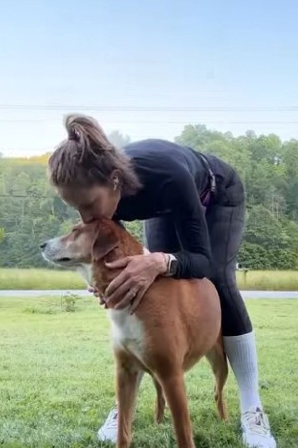 girl kissing a dog