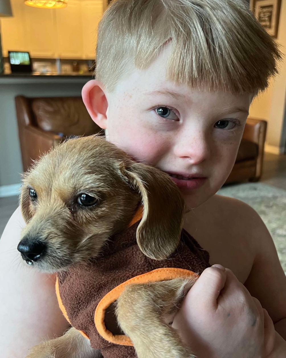 kid holding a puppy