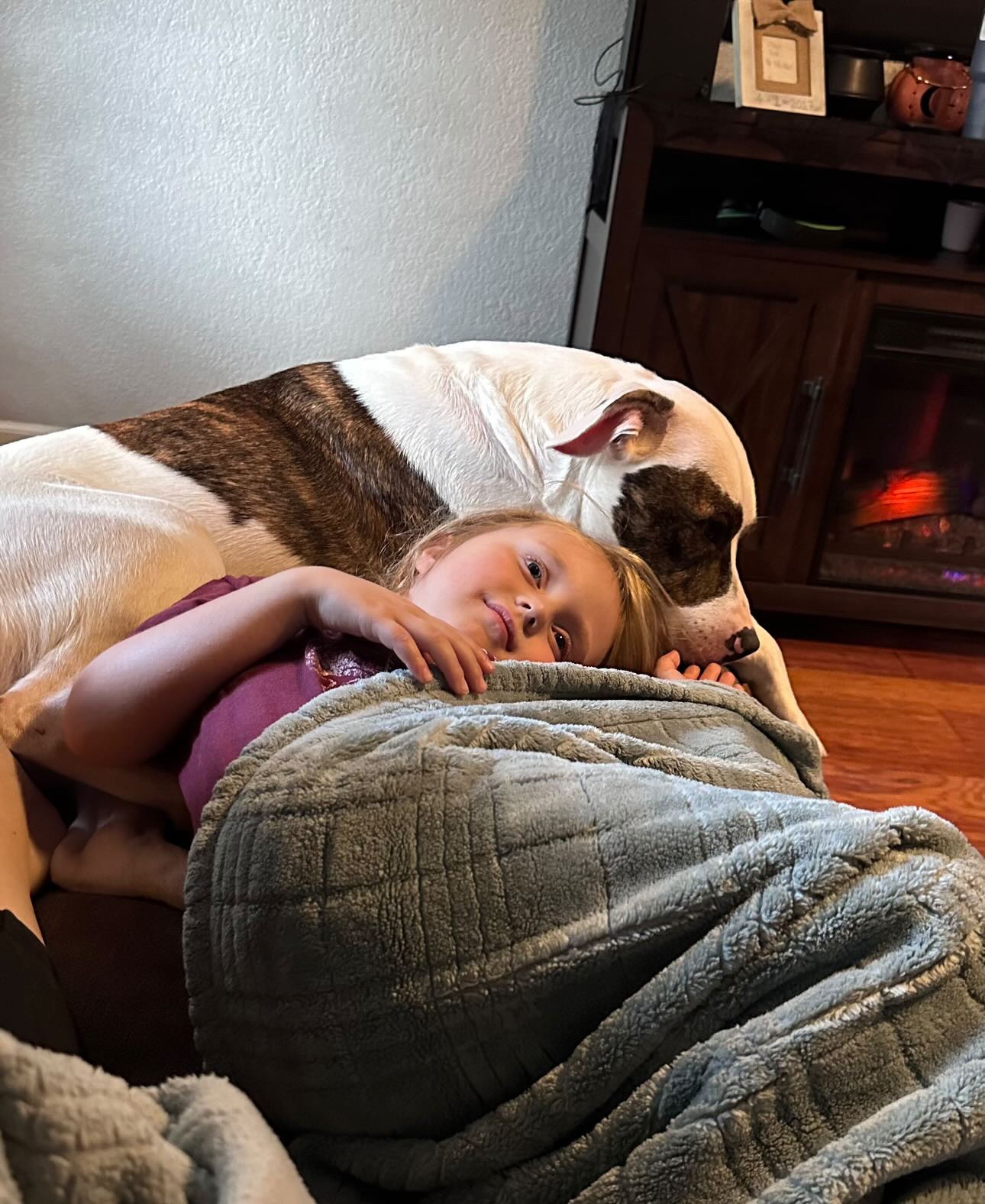 little girl cuddling the dog 