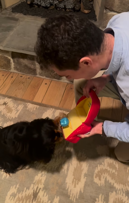 man and dog in house