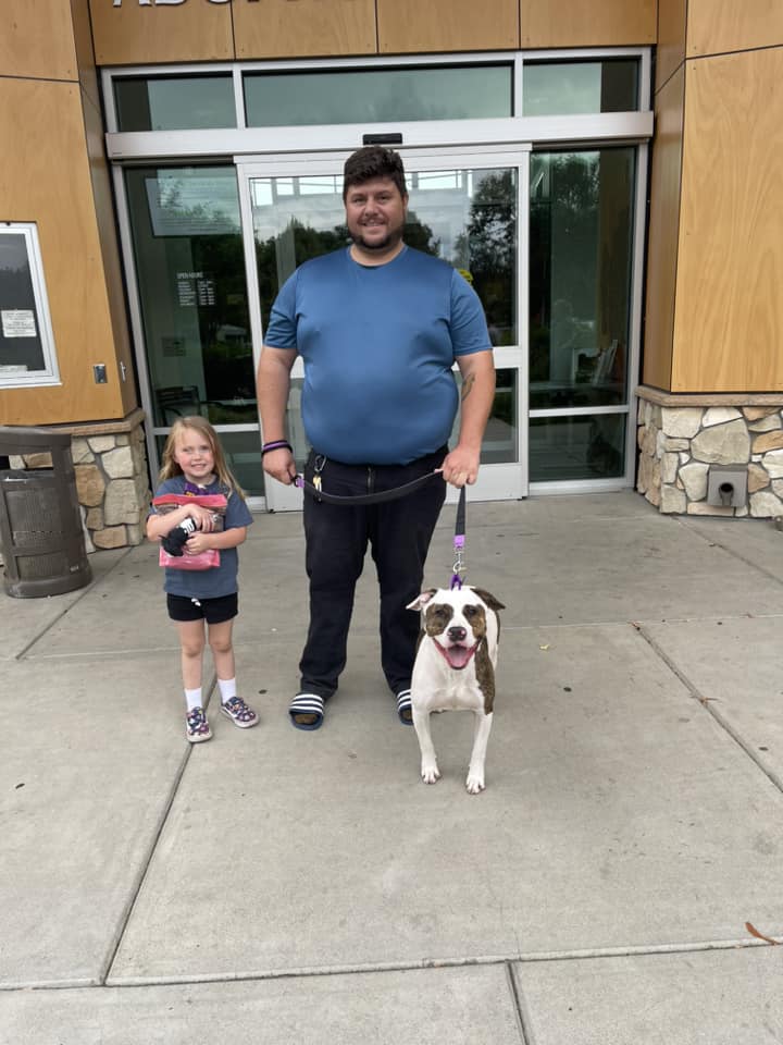 man and little girl with a dog