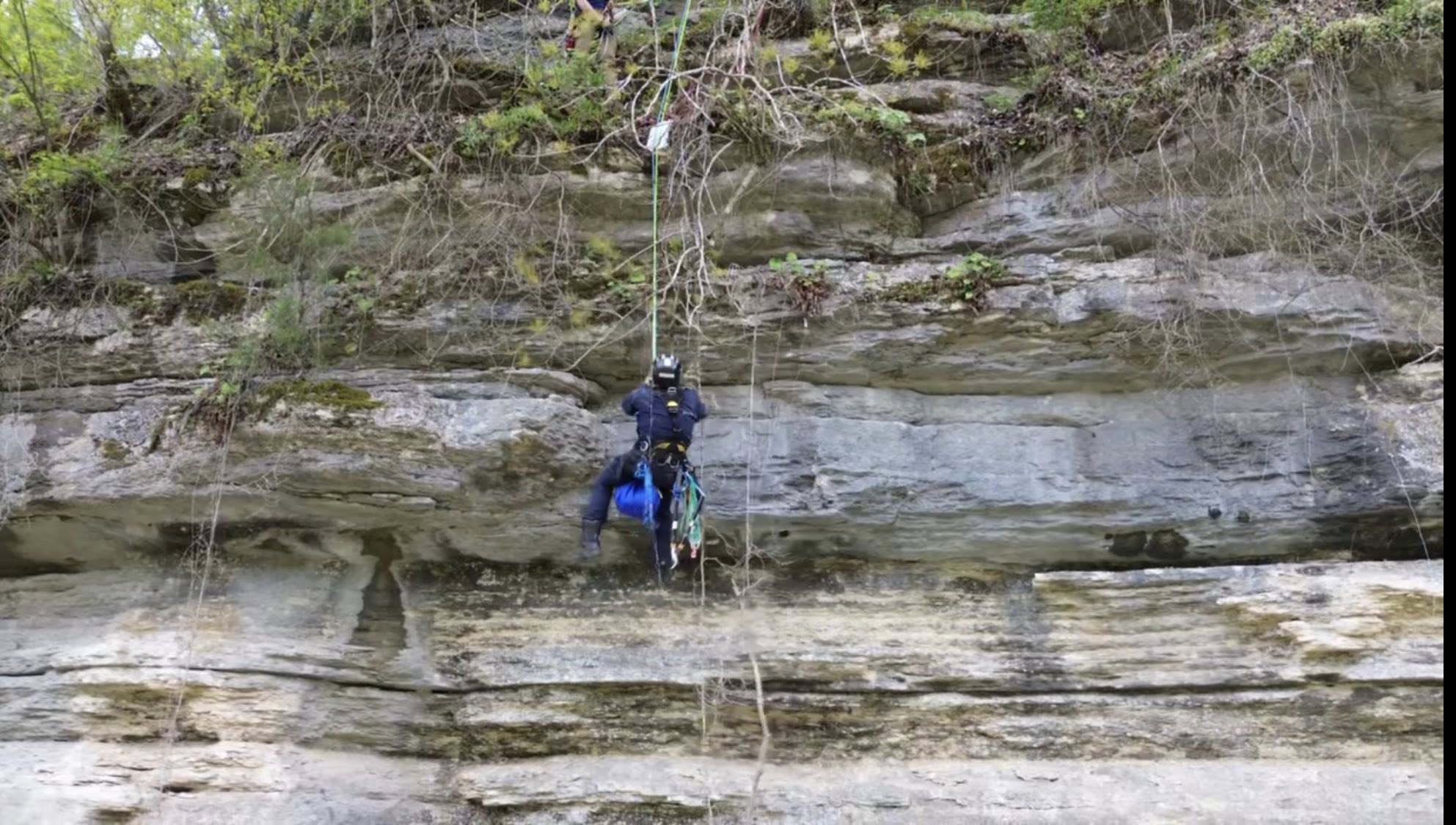 man climbing on cliff