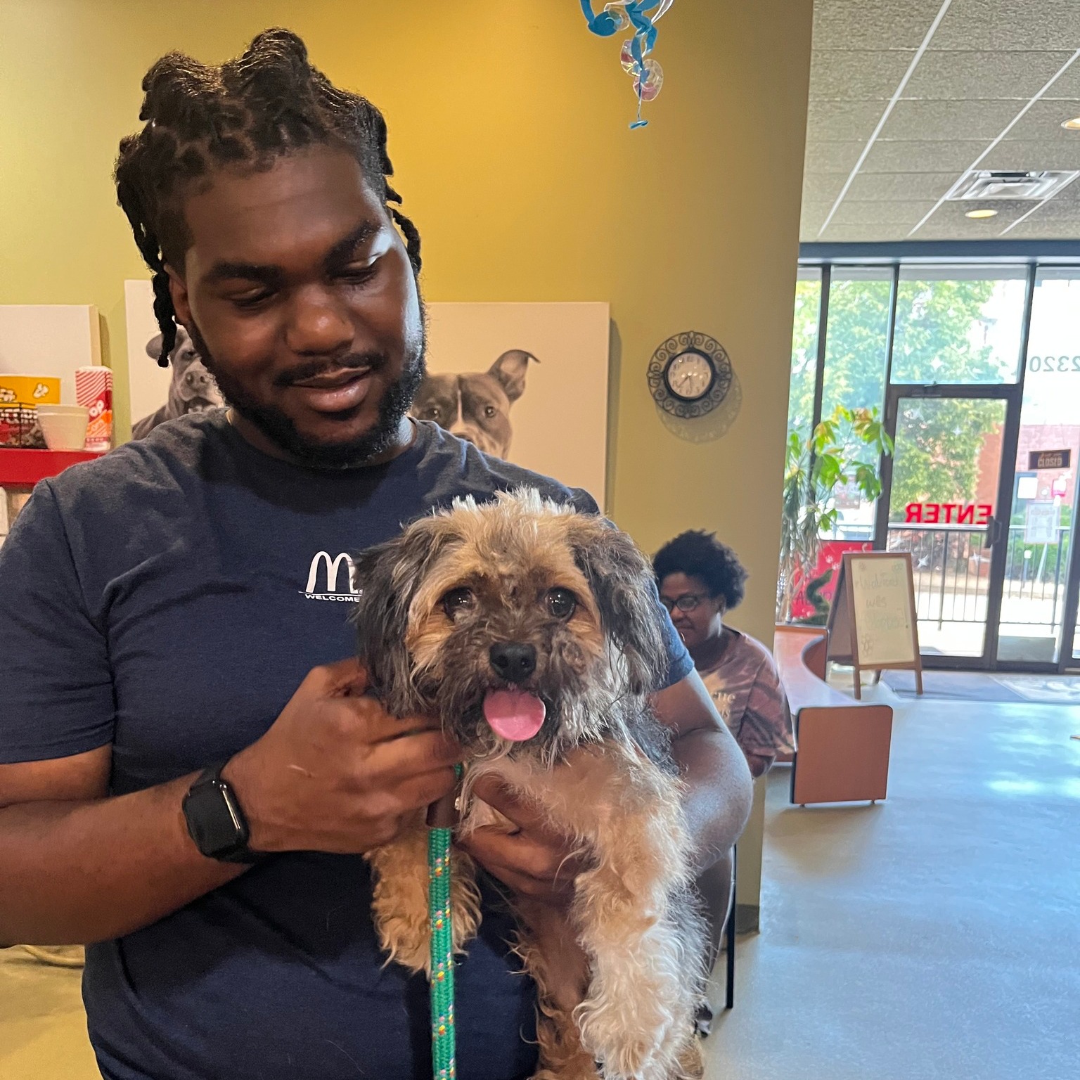 man holding a stray dog