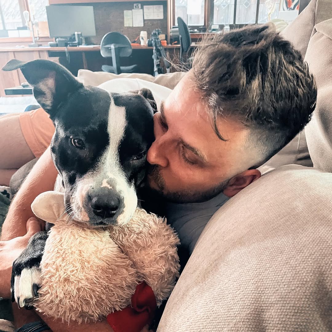 man kissing his dog