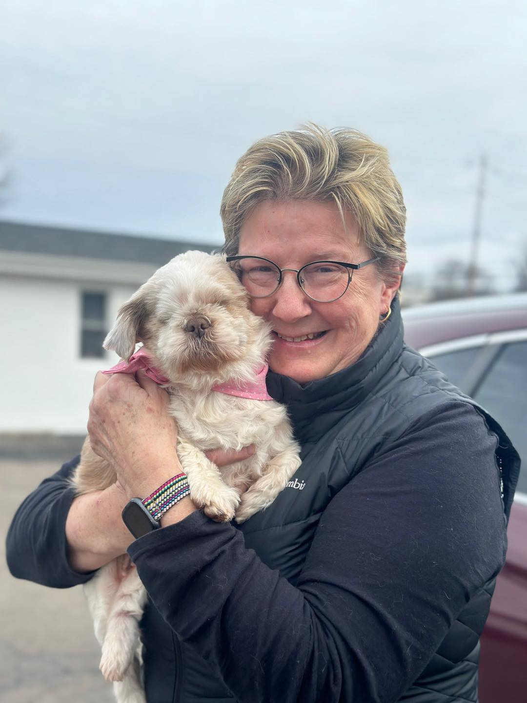 old woman holding a dog