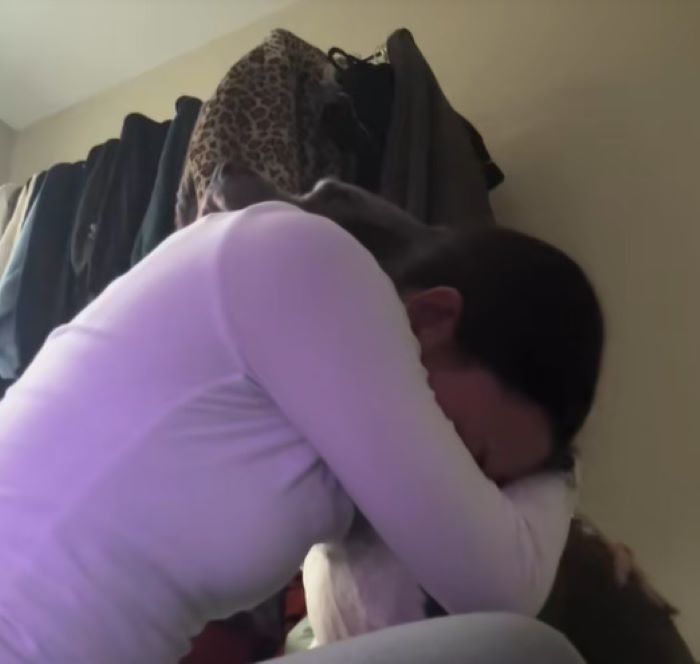 sad woman hugging a dog