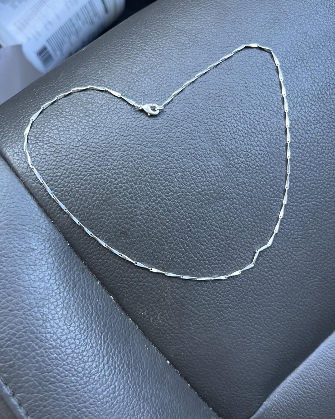silver necklace in car