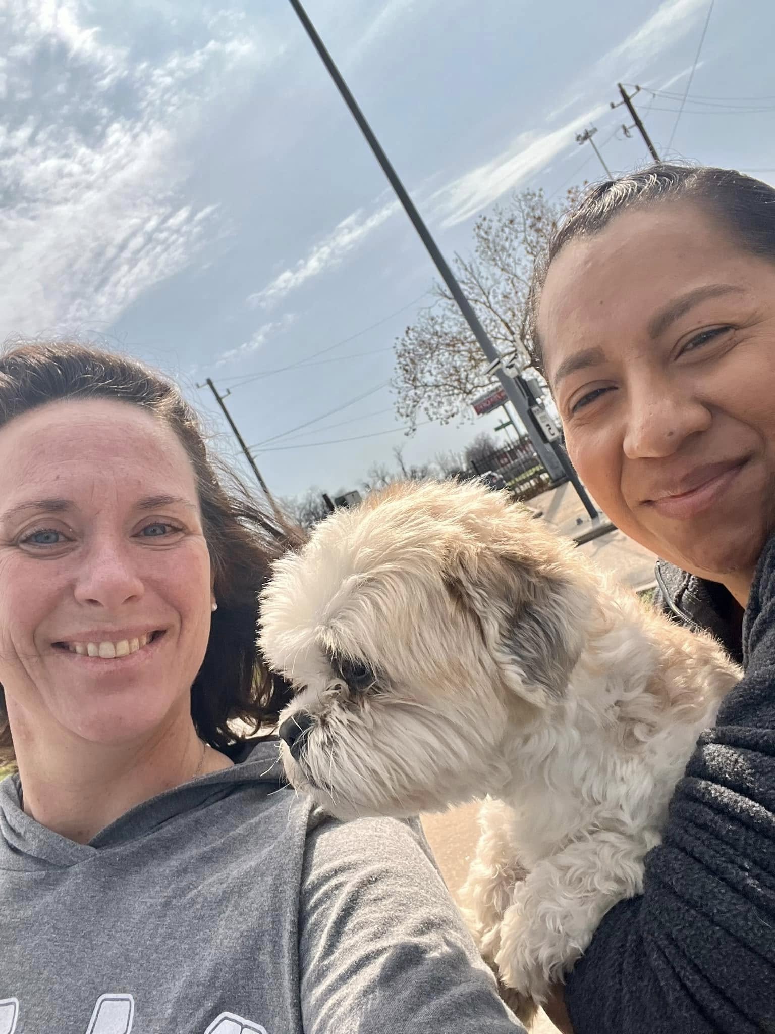 two women holding a dog
