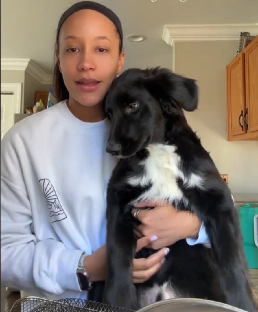 woman and adopted black dog