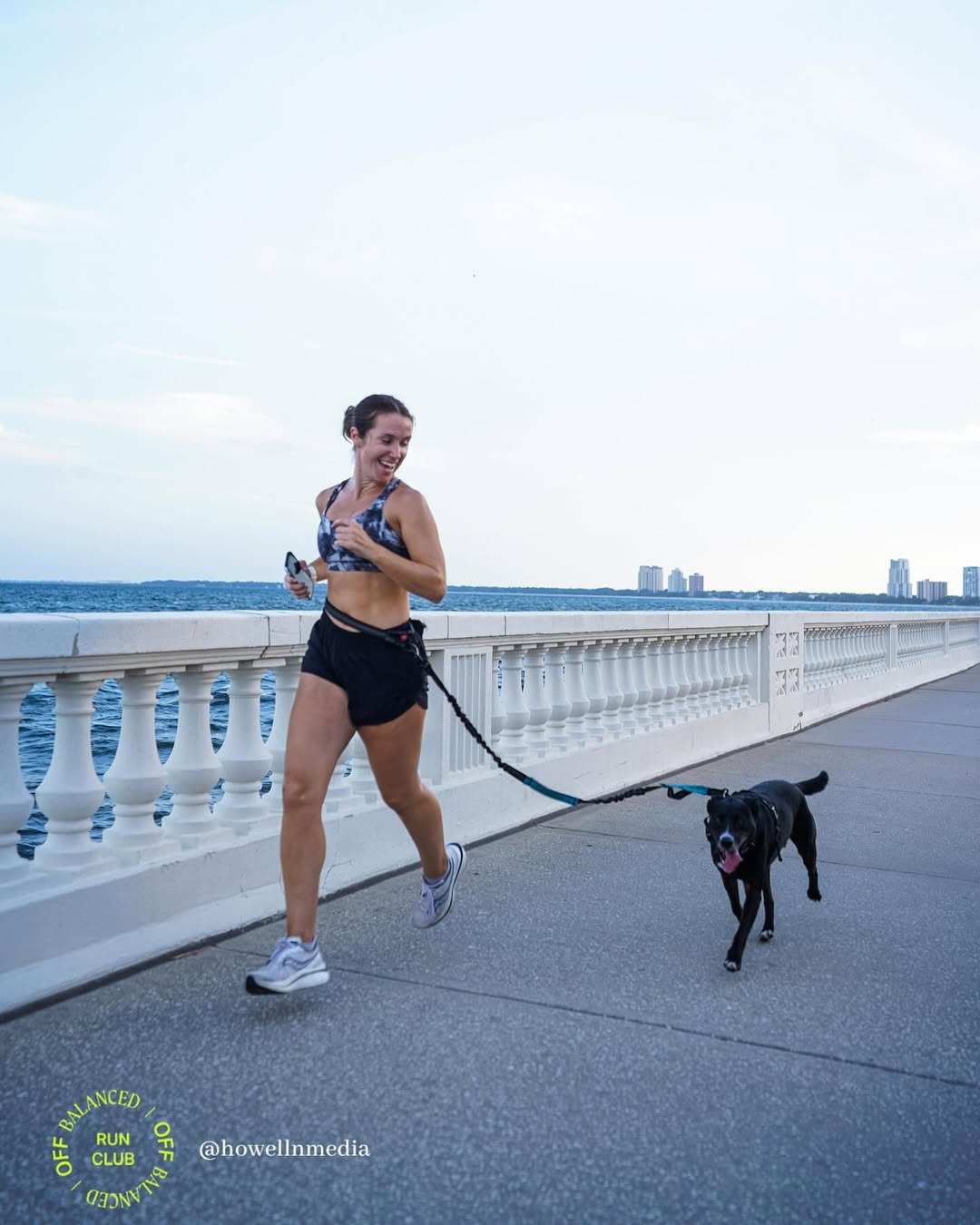 woman and black dog running