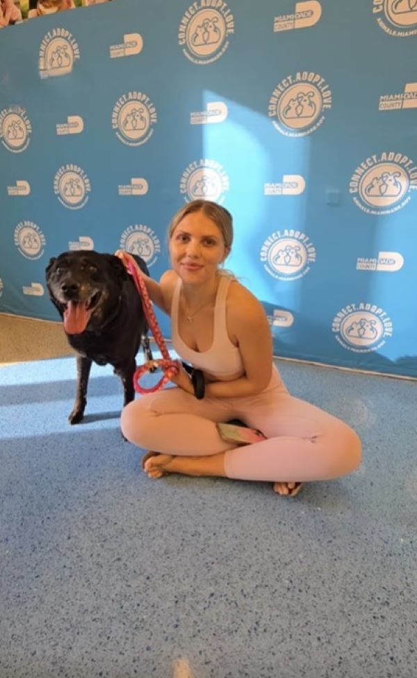 woman and cute black dog
