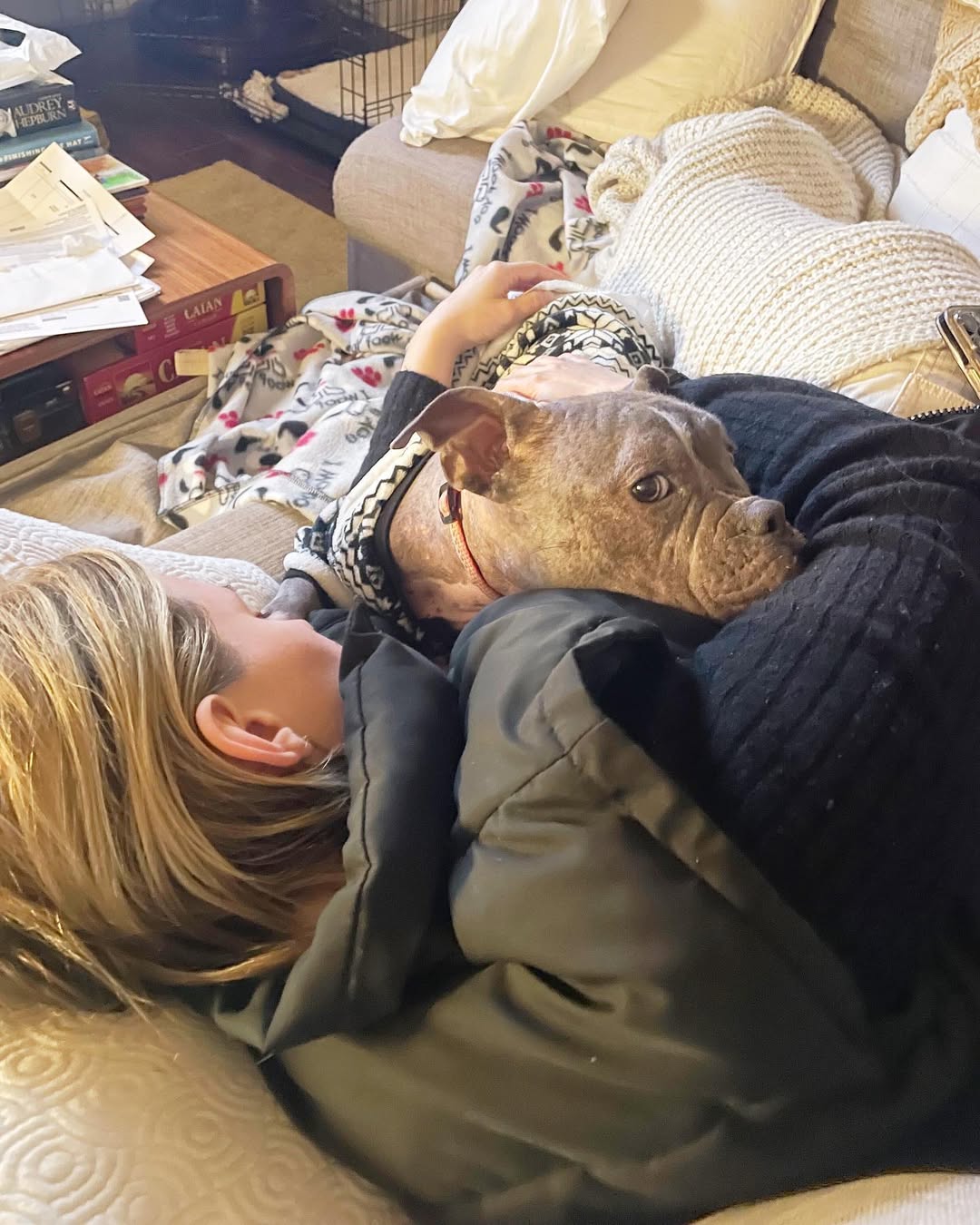 woman and dog laying together