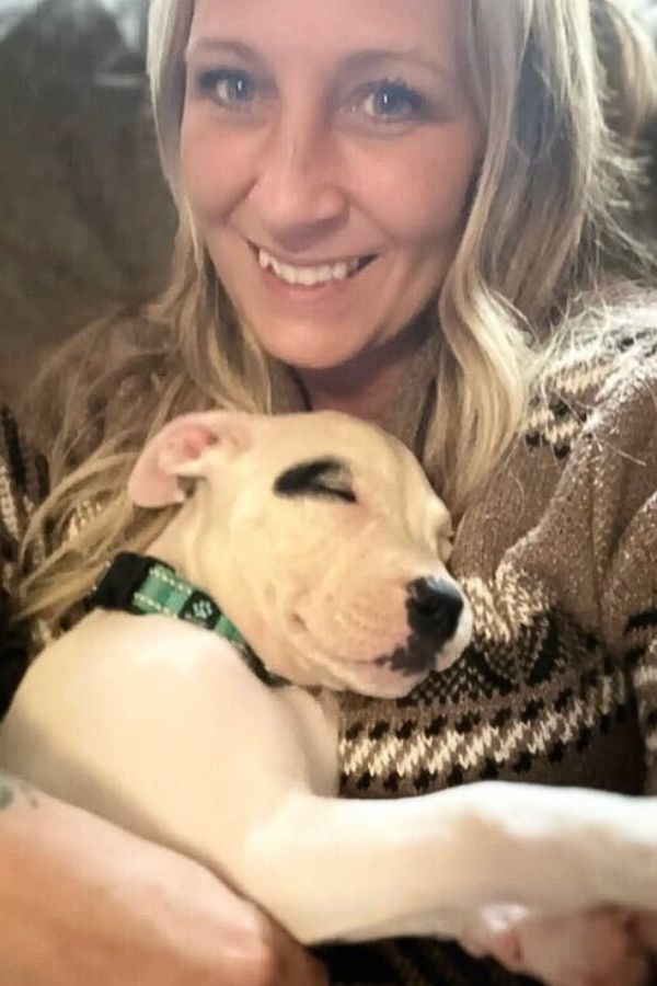 woman and white puppy