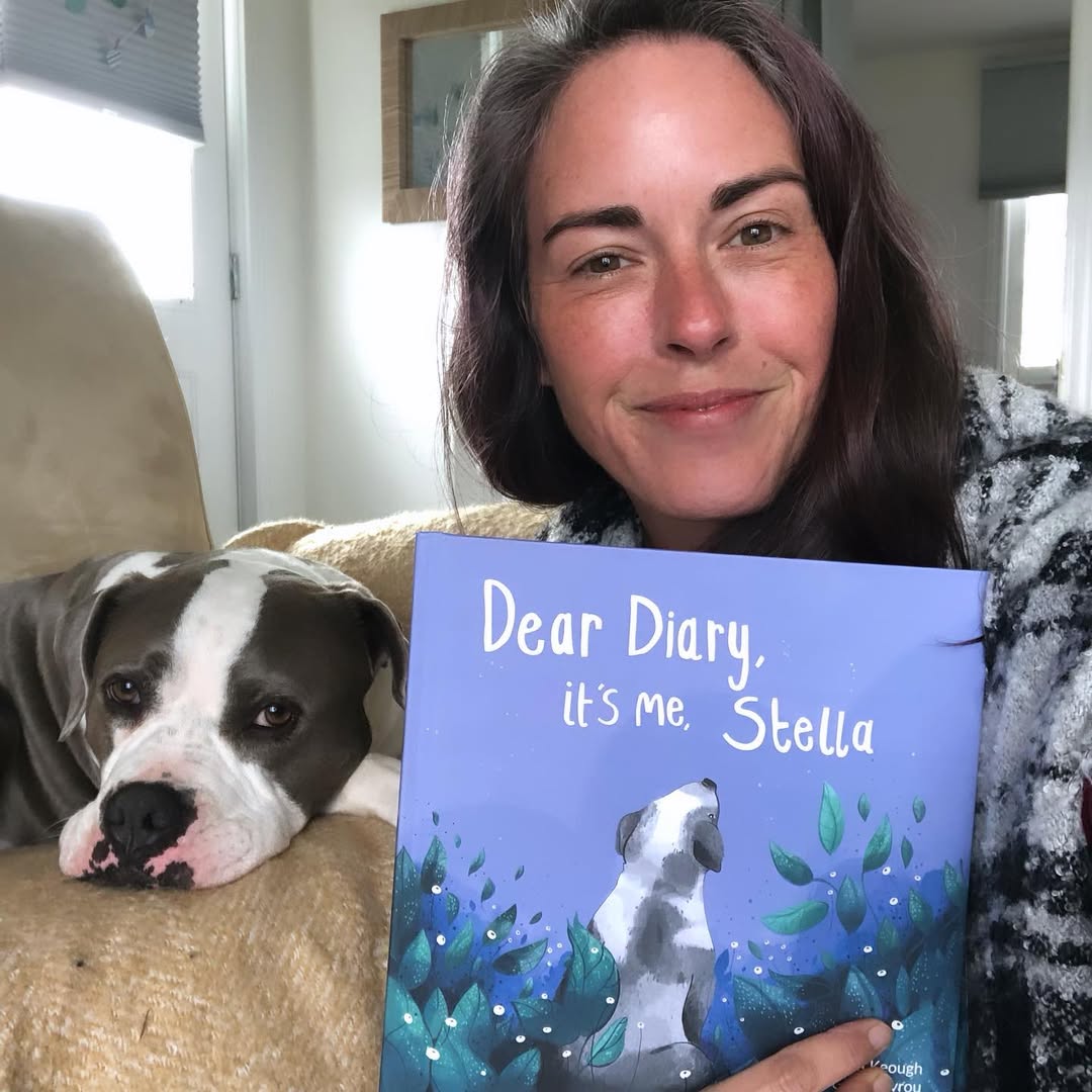 woman holding a book about a dog