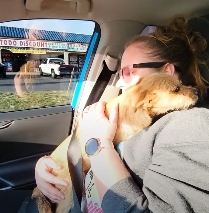 woman holding an injured dog