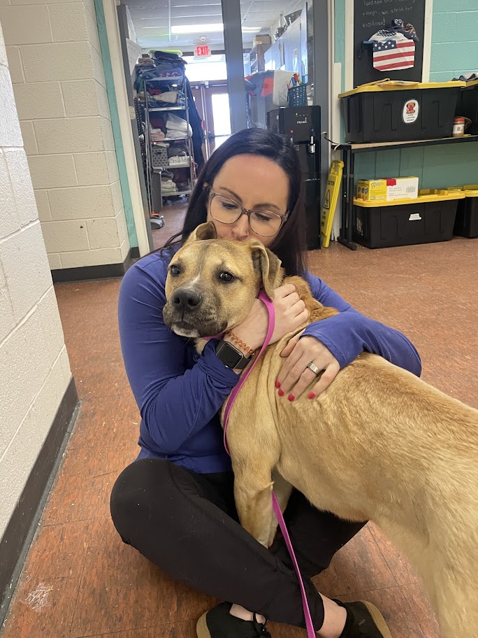 woman hugging a dog