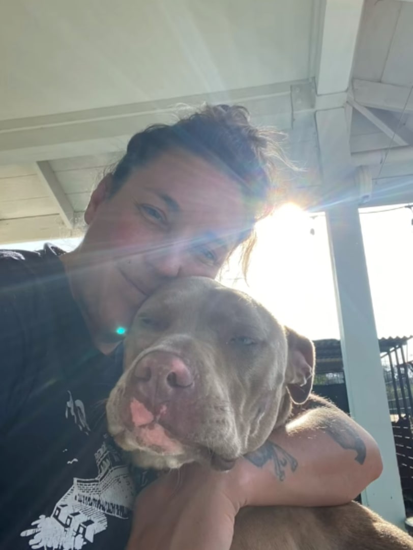woman hugging a dog