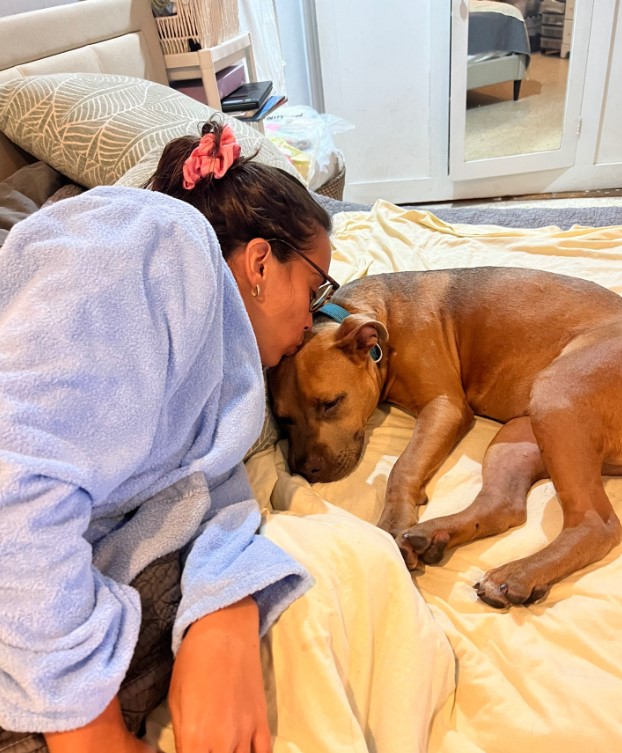 woman kissing a dog
