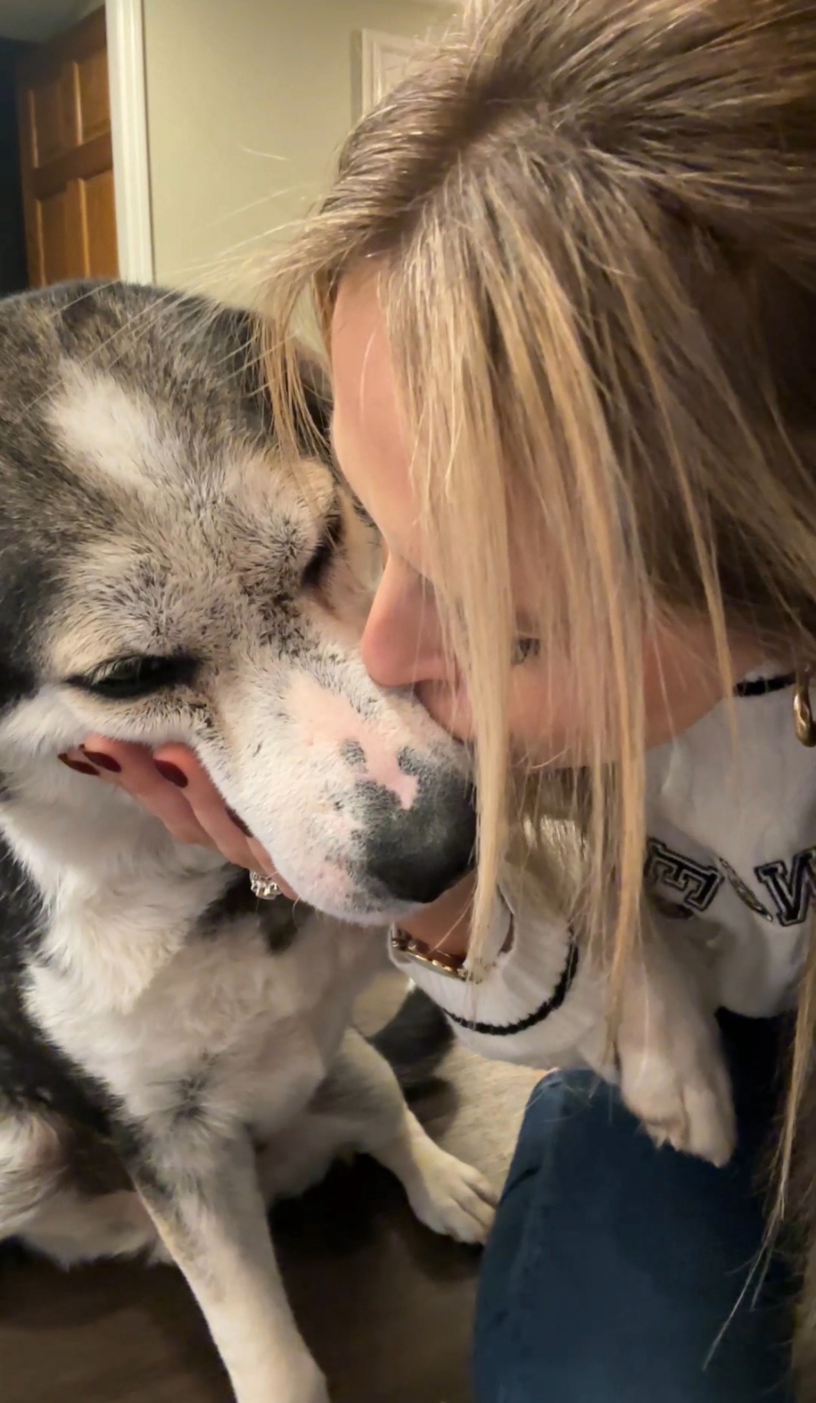 woman kissing a dog