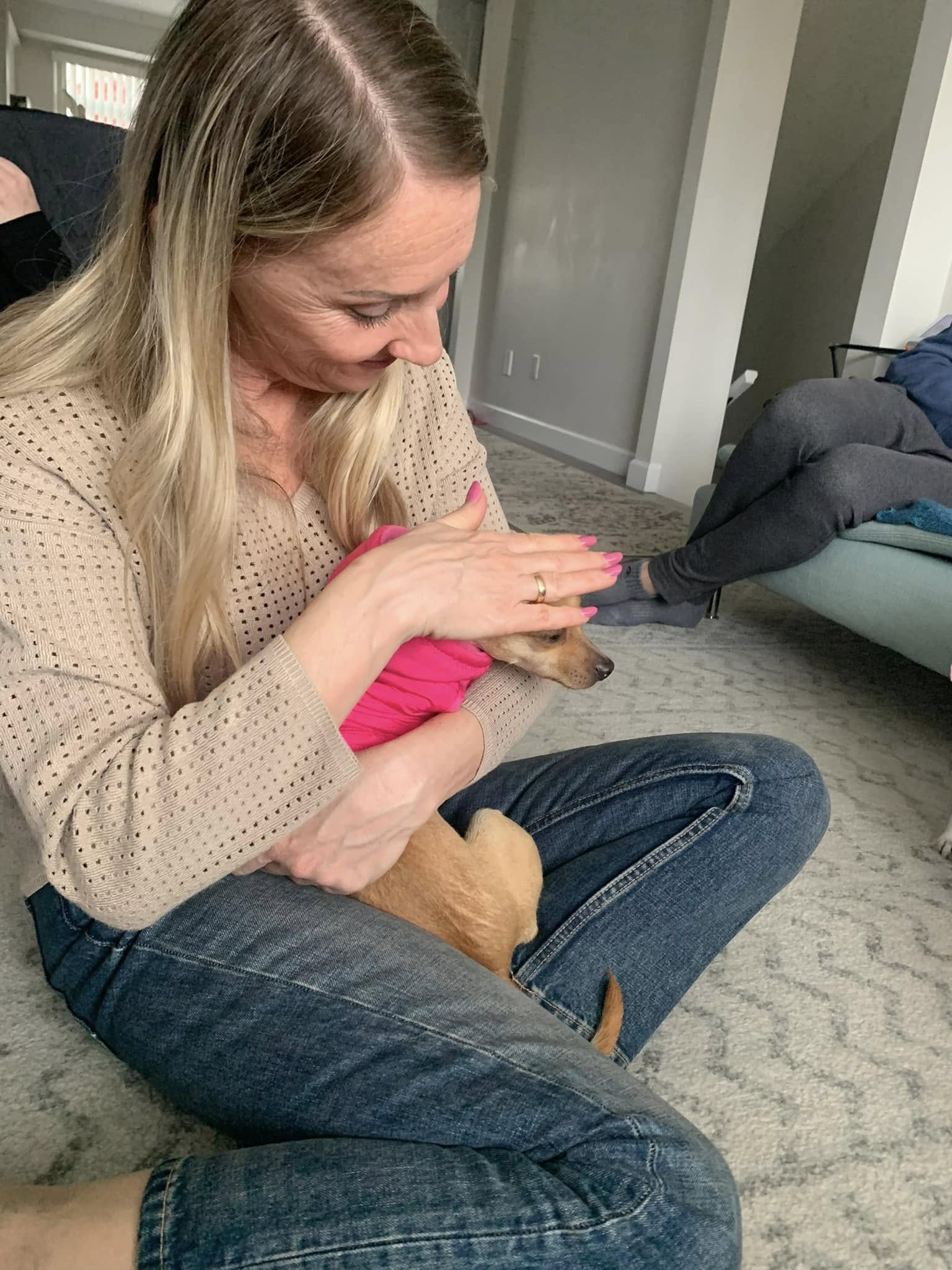 woman petting a tiny dog