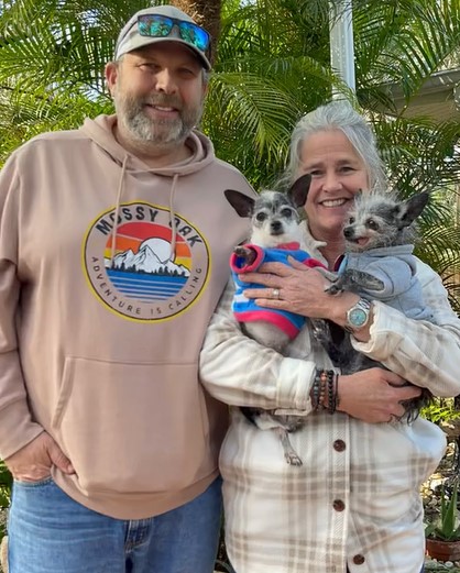 couple holding two chihuahuas 