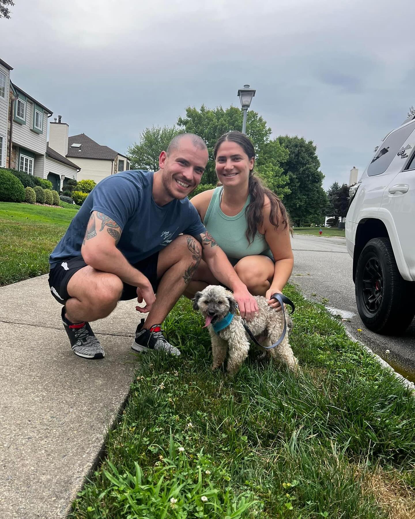 couple posing with a dog