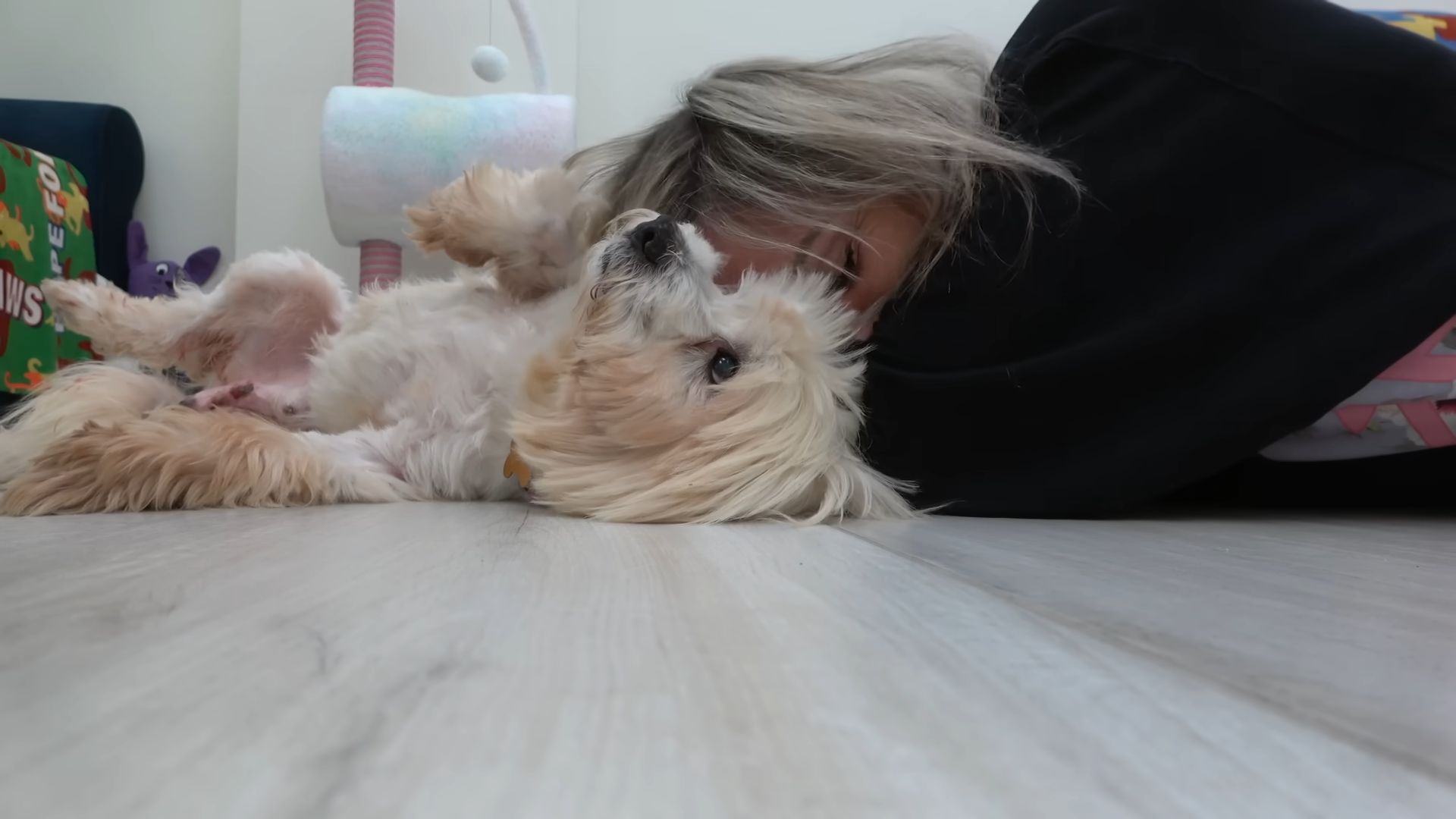 dog and woman lying on the floor 