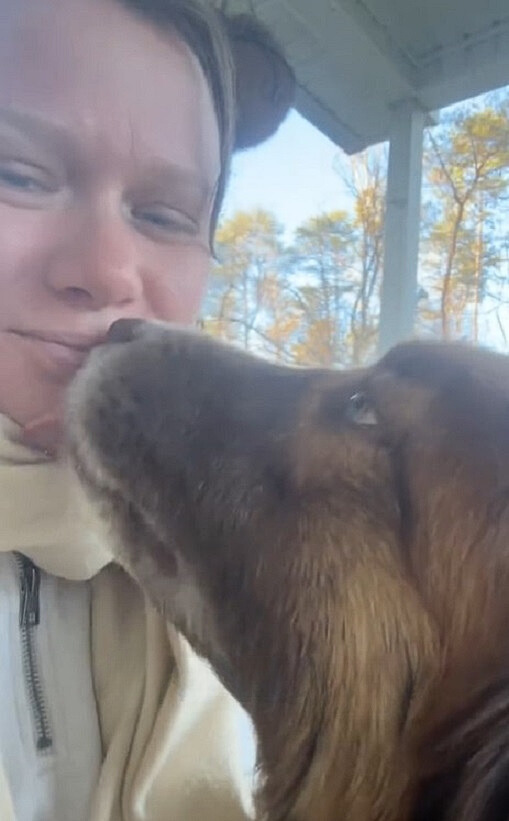 dog kisses woman