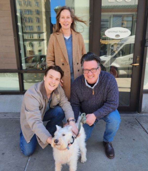 family posing with dog