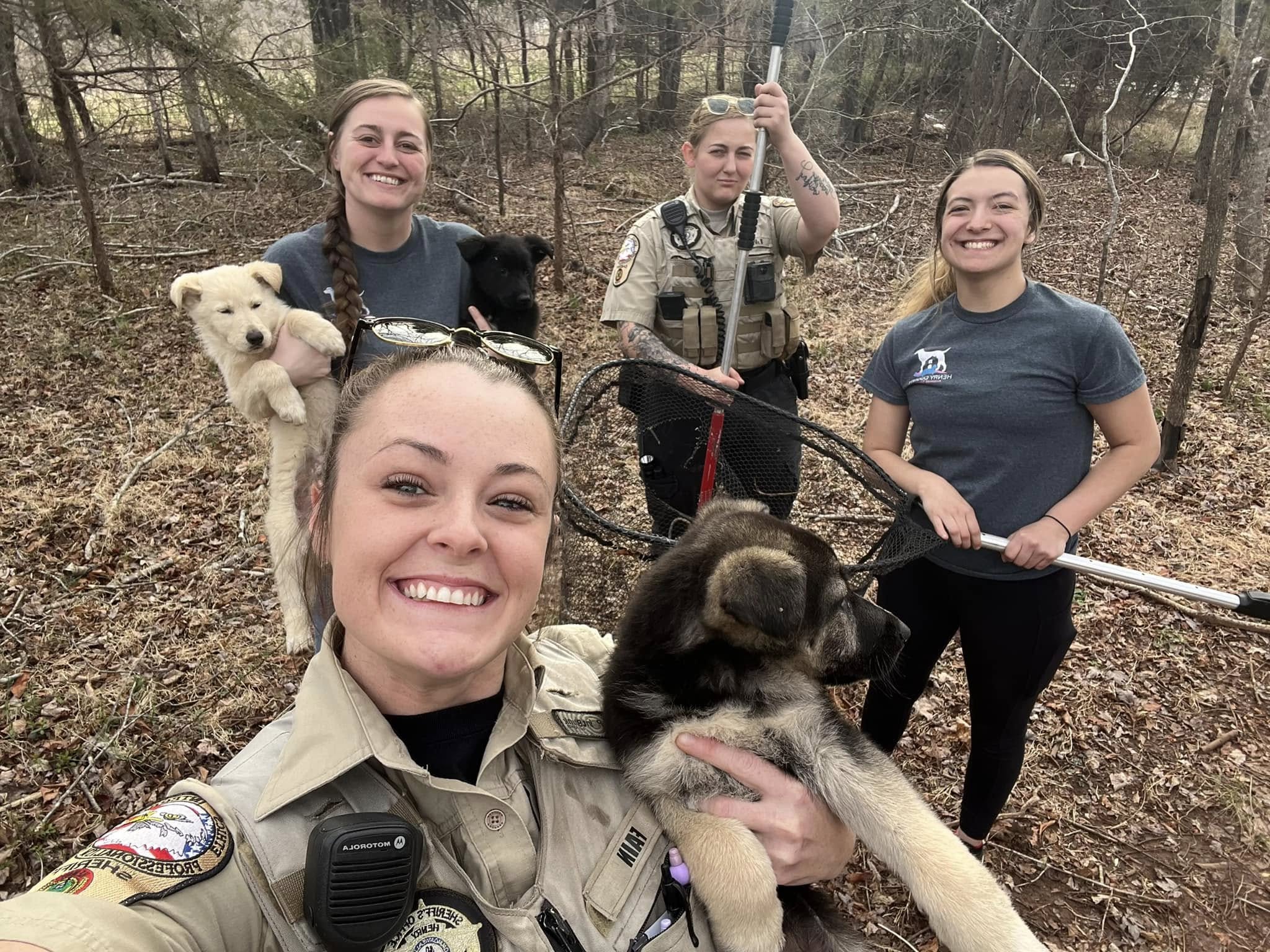 four women and puppies