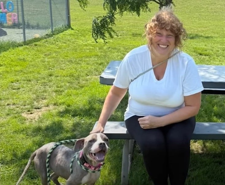 happy woman petting a dog