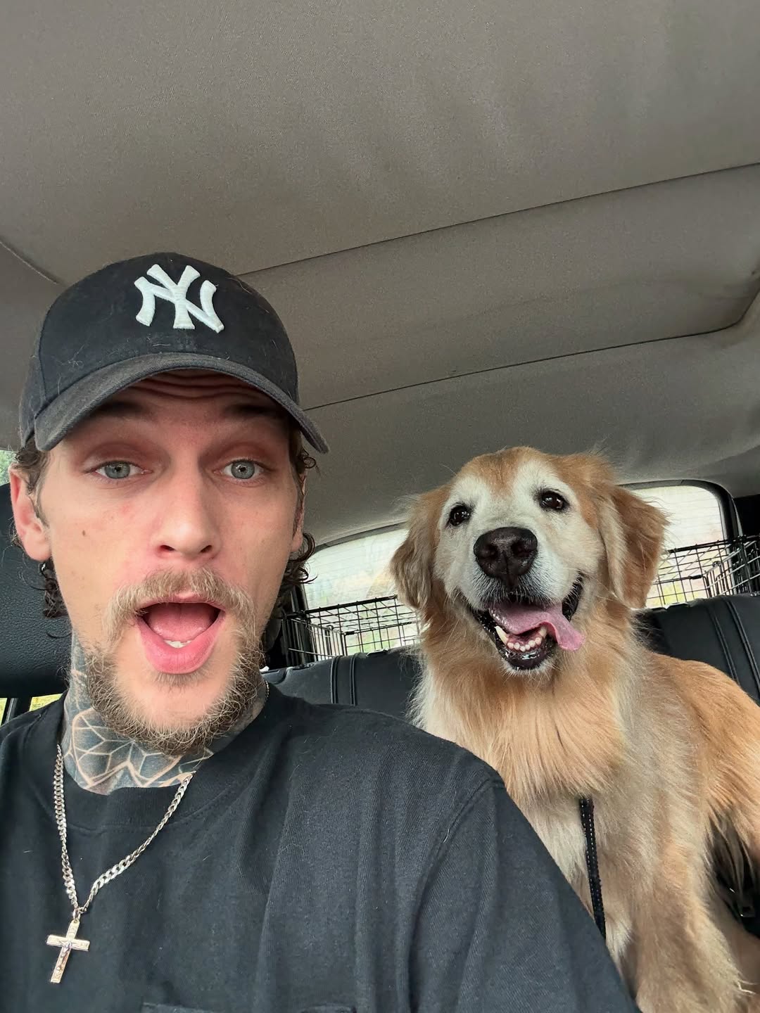 man and dog in car