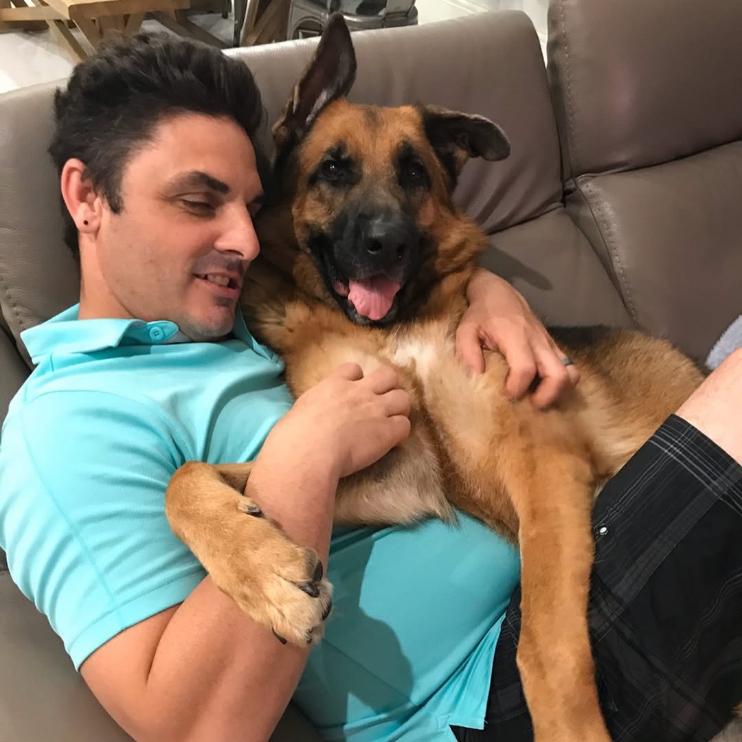 man and dog in house