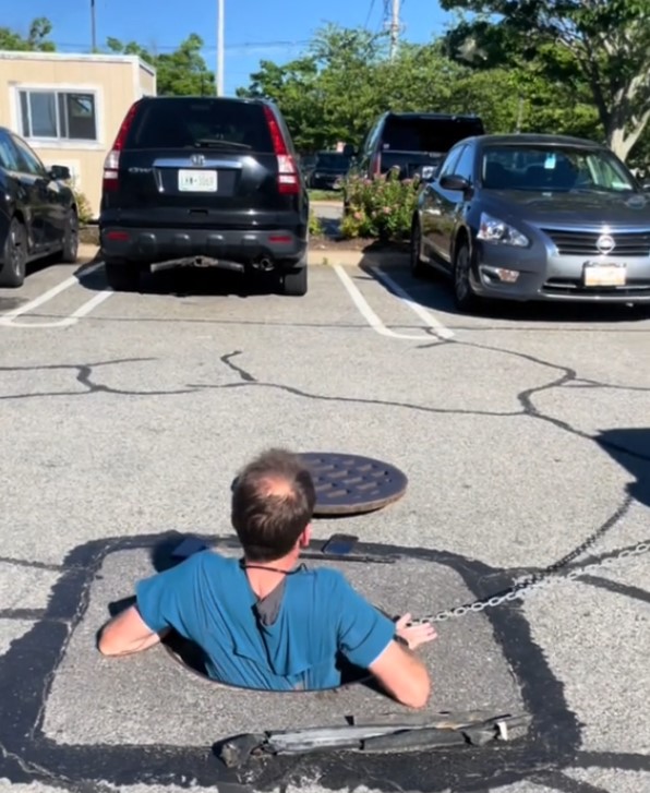 man climbing in a deep hole