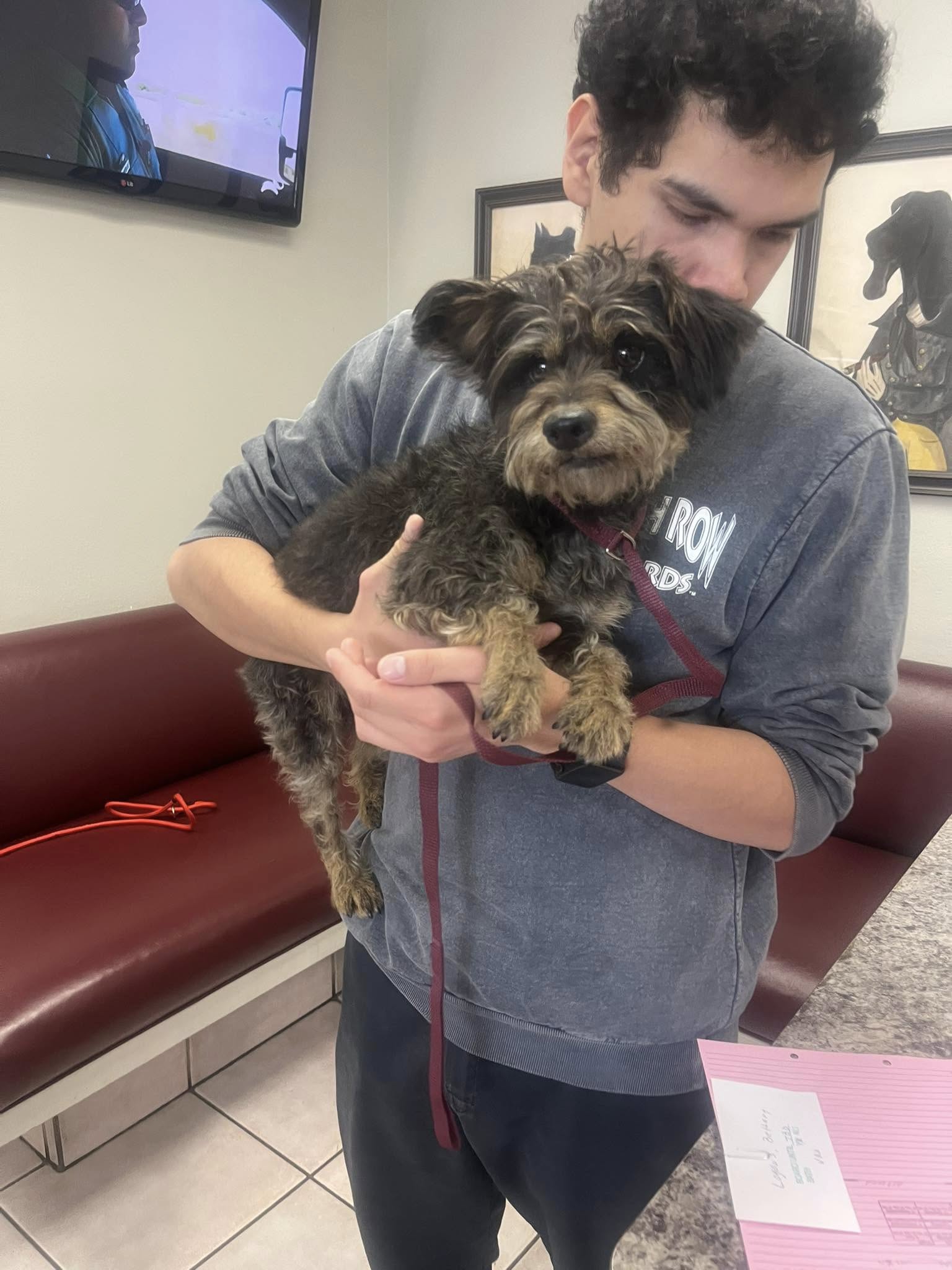 man holding a fluffy dog