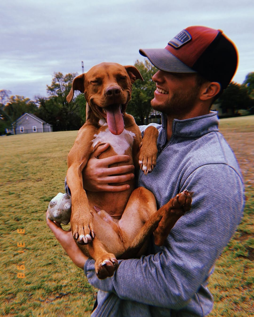 man holding a happy dog
