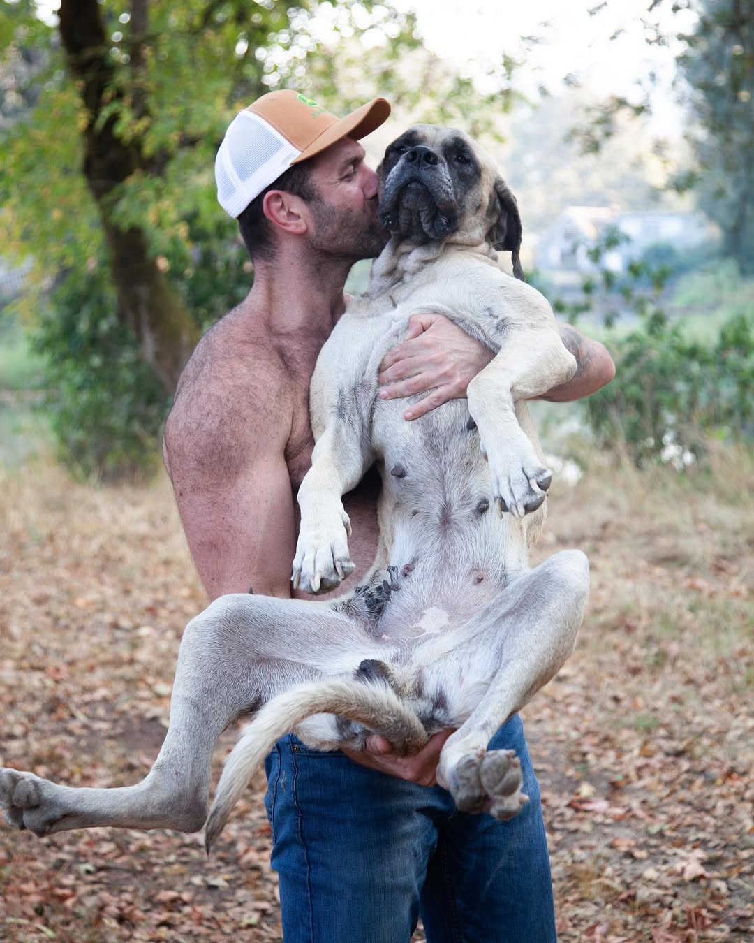 man holding a large dog