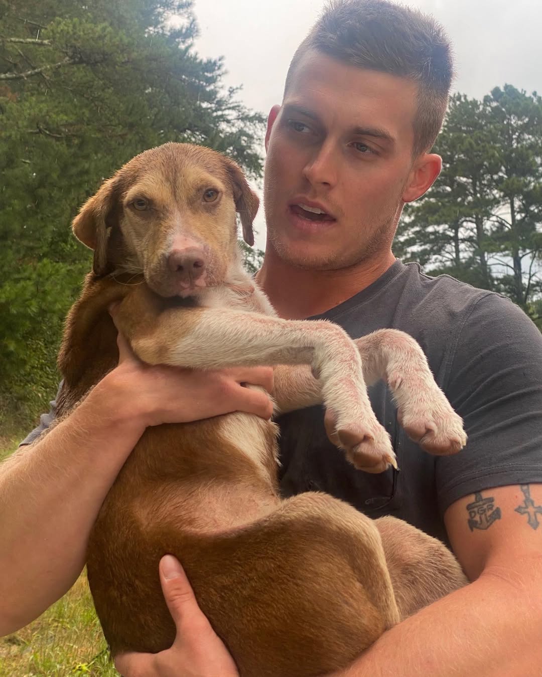 man holding a stray dog