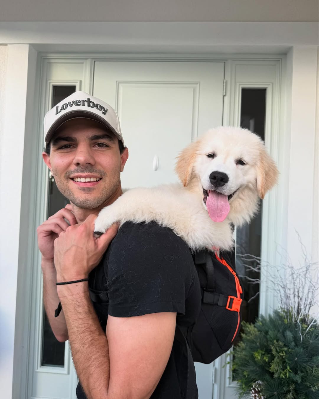 man holding a white dog