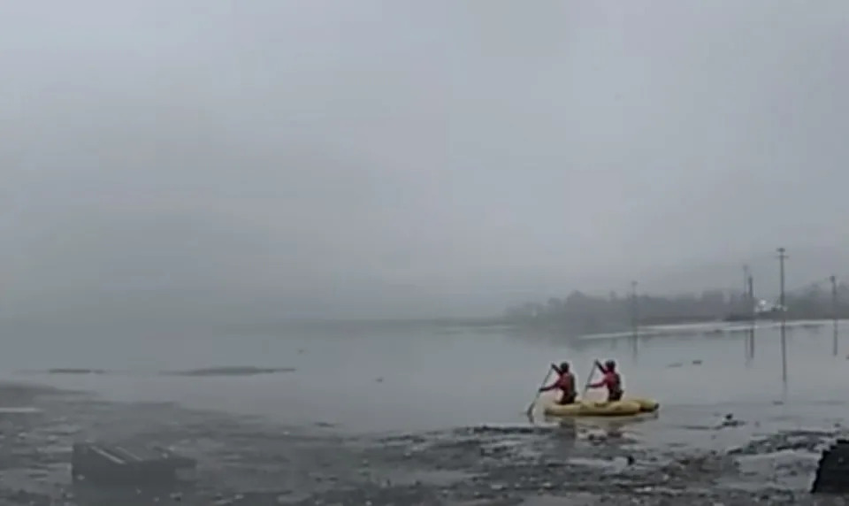 rescuers in flooded river