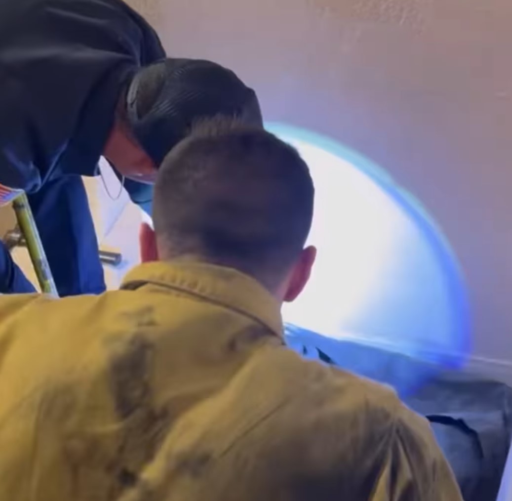 rescuers looking at the wall